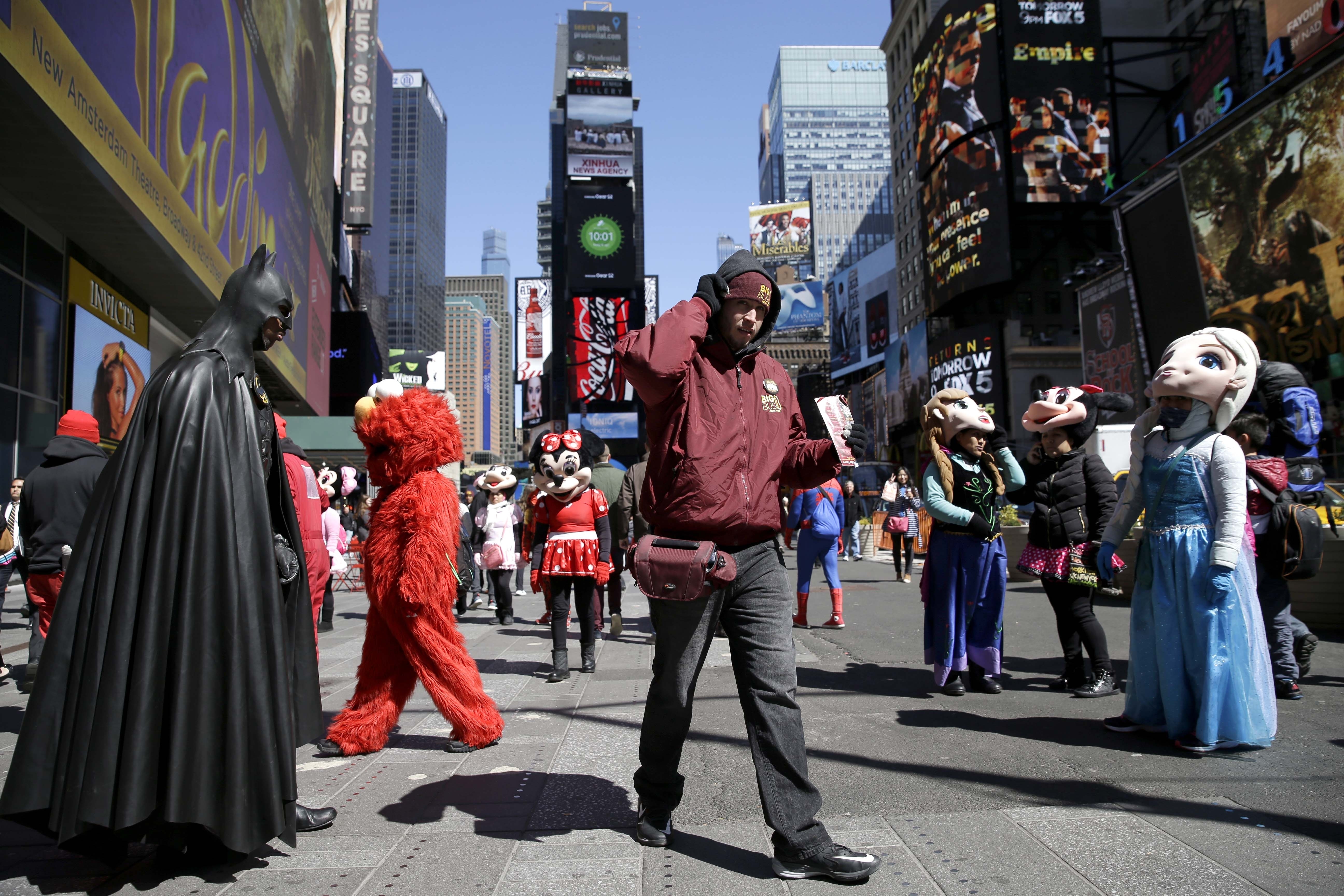 The Latest: 3 Times Square performers arrested in tips spat