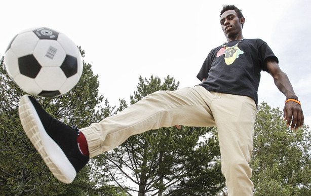 Refugee foster care graduate Patrick Aime juggles a soccer ball during a high school graduation party at Jordan Park in Salt Lake City on Friday, June 10, 2016. (Photo: Weston Kenney, Deseret News)