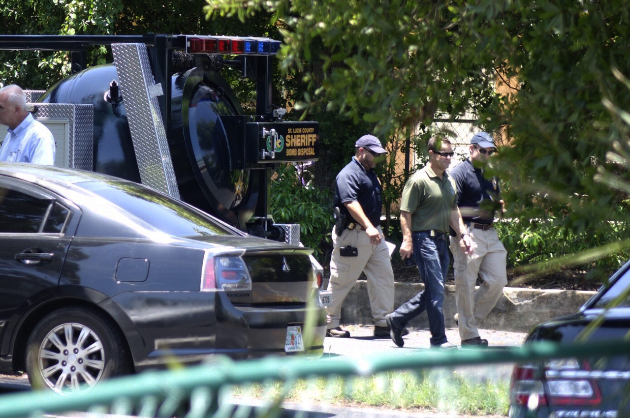 Law enforcement personnel gather at a Fort Pierce, Fla. residence related to the Orlando shooter, Omar Mateen, Sunday, June 12, 2016. (South Florida Sun-Sentinel via AP)