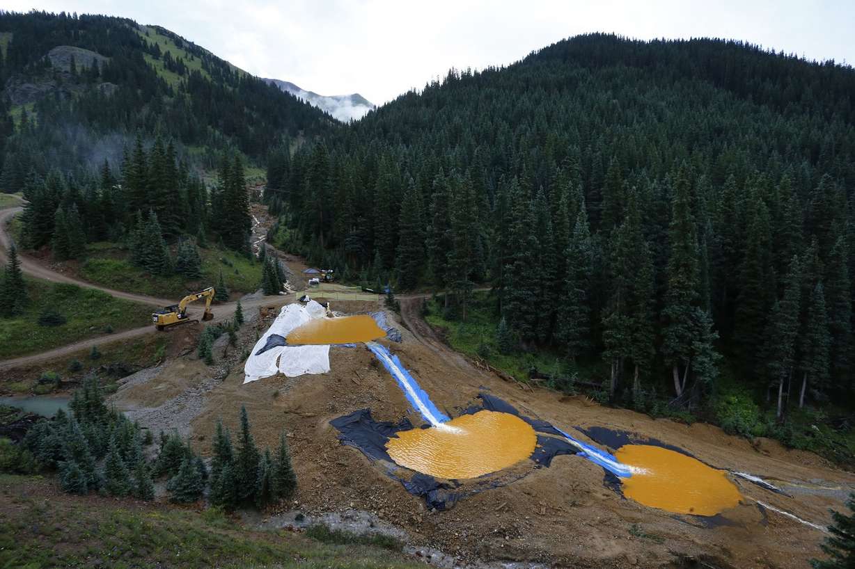 In this Aug. 12, 2015 file photo, water flows through a series of retention ponds built to contain and filter out heavy metals and chemicals from the Gold King mine chemical accident, in the spillway about 1/4 mile downstream from the mine, outside Silverton, Colo. A U.S. House probe of the mine waste accident in Colorado that fouled rivers in three states with arsenic, lead and other toxic substances has found further evidence that EPA workers knew a spill from the gold mine was possible, according to documents released Thursday, Feb. 11, 2016 by a U.S. House committee. (AP Photo/Brennan Linsley, file) (Photo: Brennan Linsley, Associated Press)