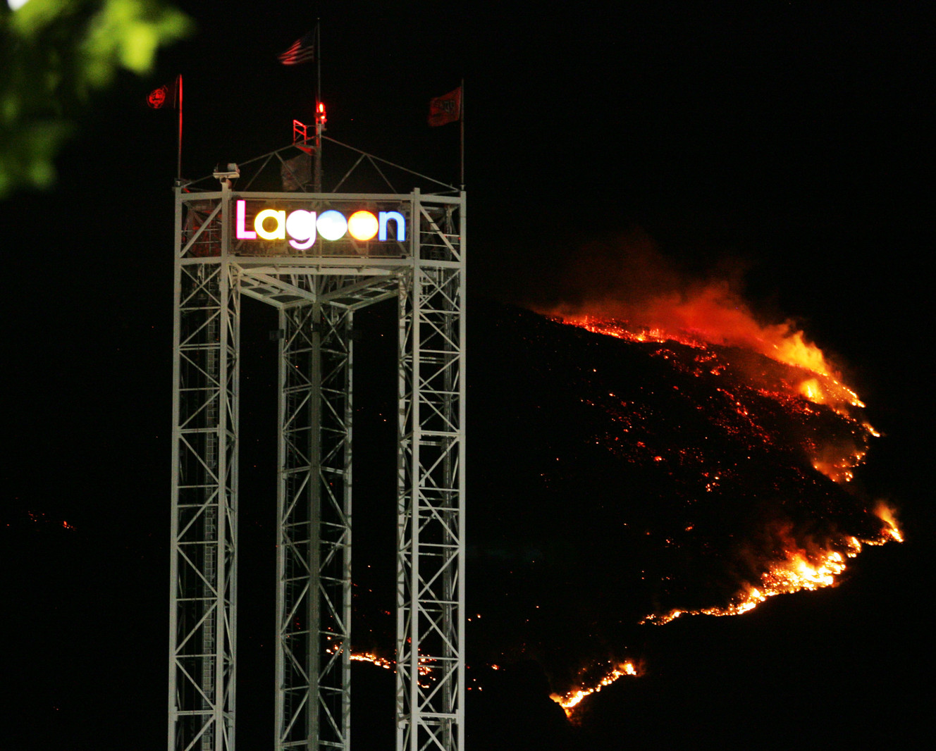 A 300 acre brush fire lights up the mountain behind the Lagoon Amusement Park in Farmington early Sunday morning, August 12, 2007. Firefighters worked Saturday evening to keep the fire away from a Farmington subdivision. Flames burned within a half mile of homes but no one was evacuated. (Brian Nicholson, Deseret News Archives)