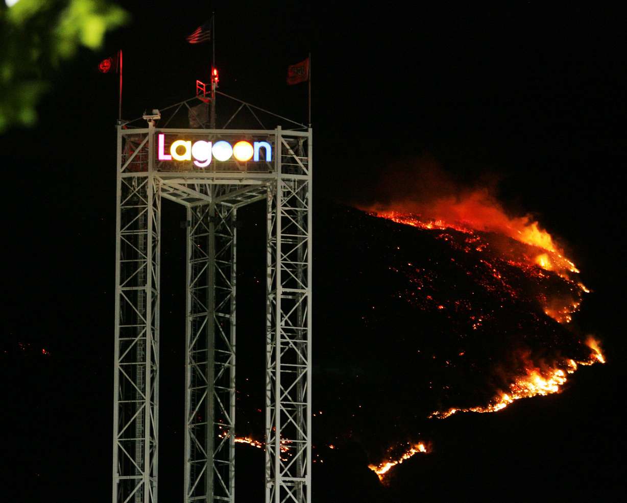 A 300 acre brush fire lights up the mountain behind the Lagoon Amusement Park in Farmington early Sunday morning, August 12, 2007. Firefighters worked Saturday evening to keep the fire away from a Farmington subdivision. Flames burned within a half mile of homes but no one was evacuated. (Brian Nicholson, Deseret News Archives)