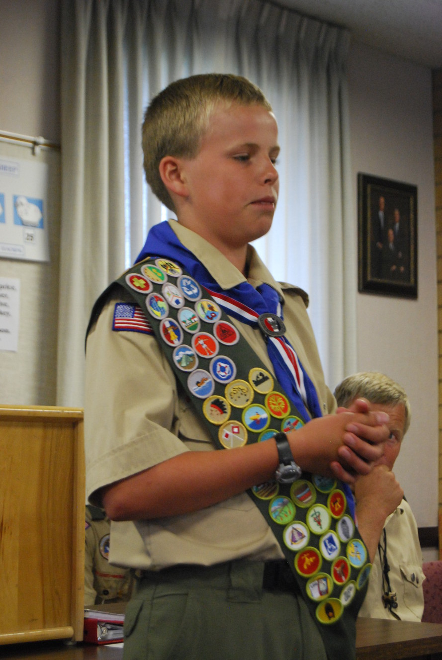 Spencer Allen displaying many of his merit badges. Photo credit: Melanie Allen