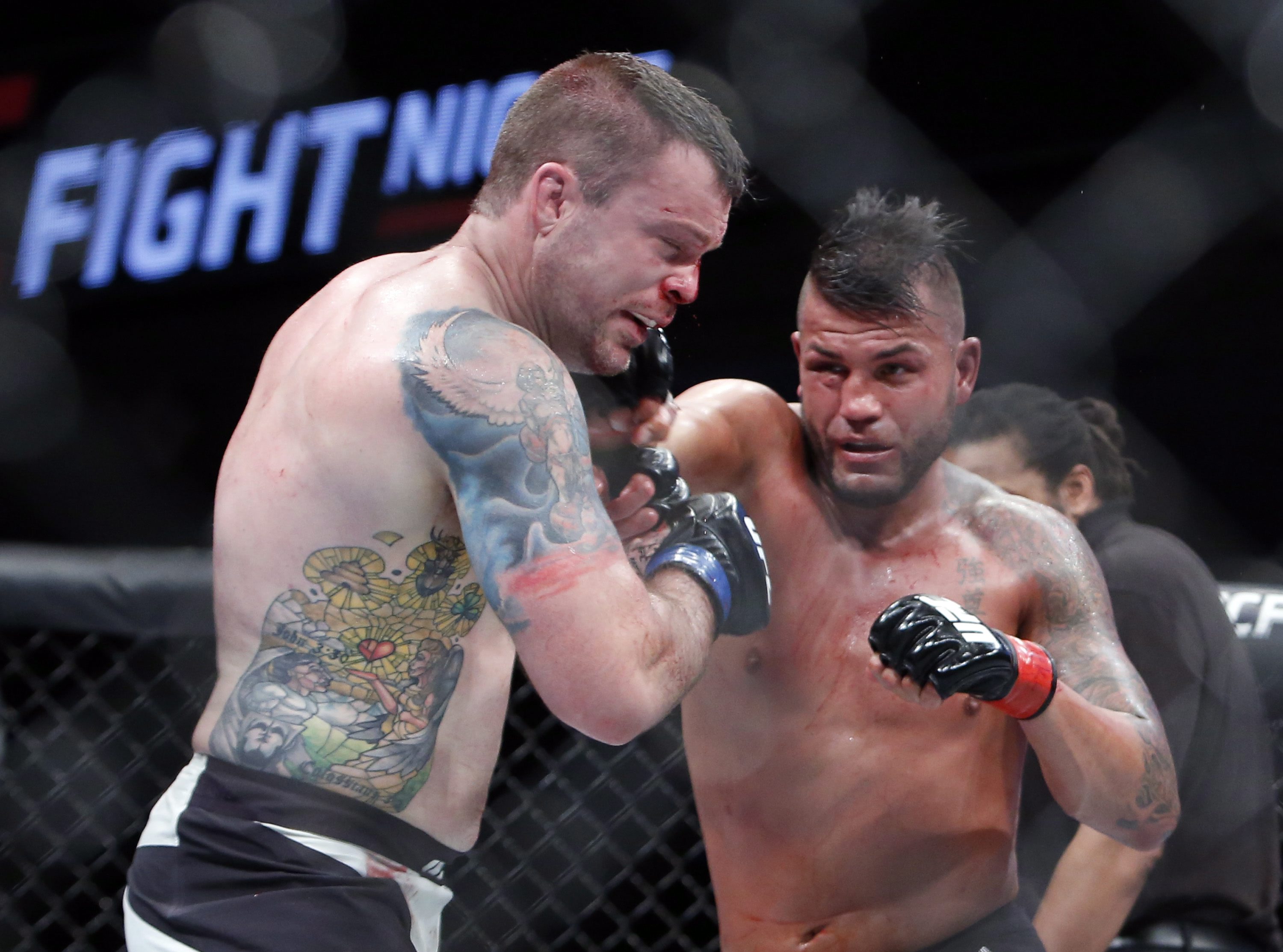 Steve Bosse, right, lands a punch to the head of Sean O'Connell during their UFC light heavyweight mixed martial arts bout Saturday, June 18, 2016, in Ottawa, Ontario. (Fred Chartrand/The Canadian Press via AP)