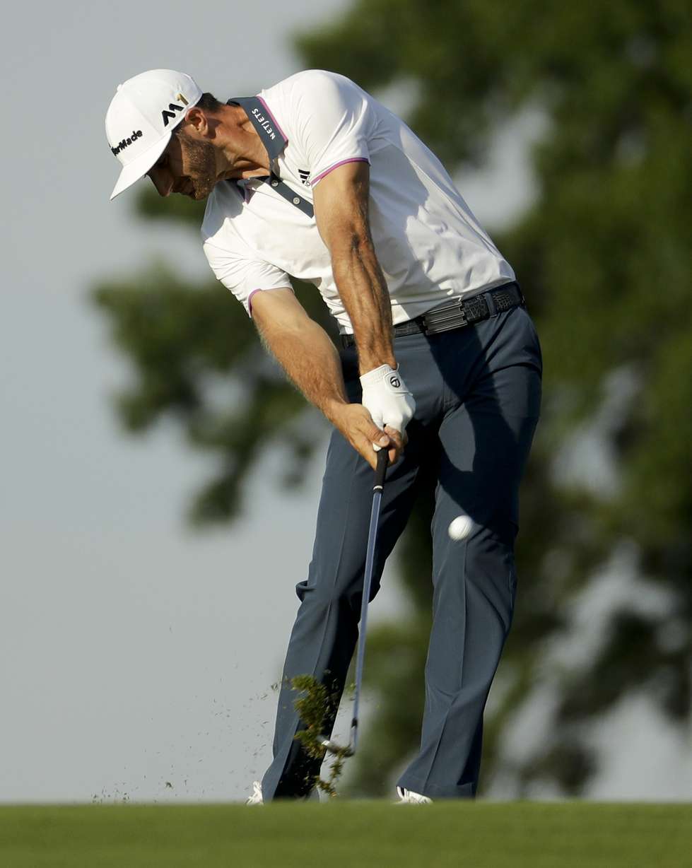 Dustin Johnson hits from the fairway on the 15th hole during the delayed third round of the U.S. Open golf championship at Oakmont Country Club on Sunday, June 19, 2016, in Oakmont, Pa. (AP Photo/Charlie Riedel)