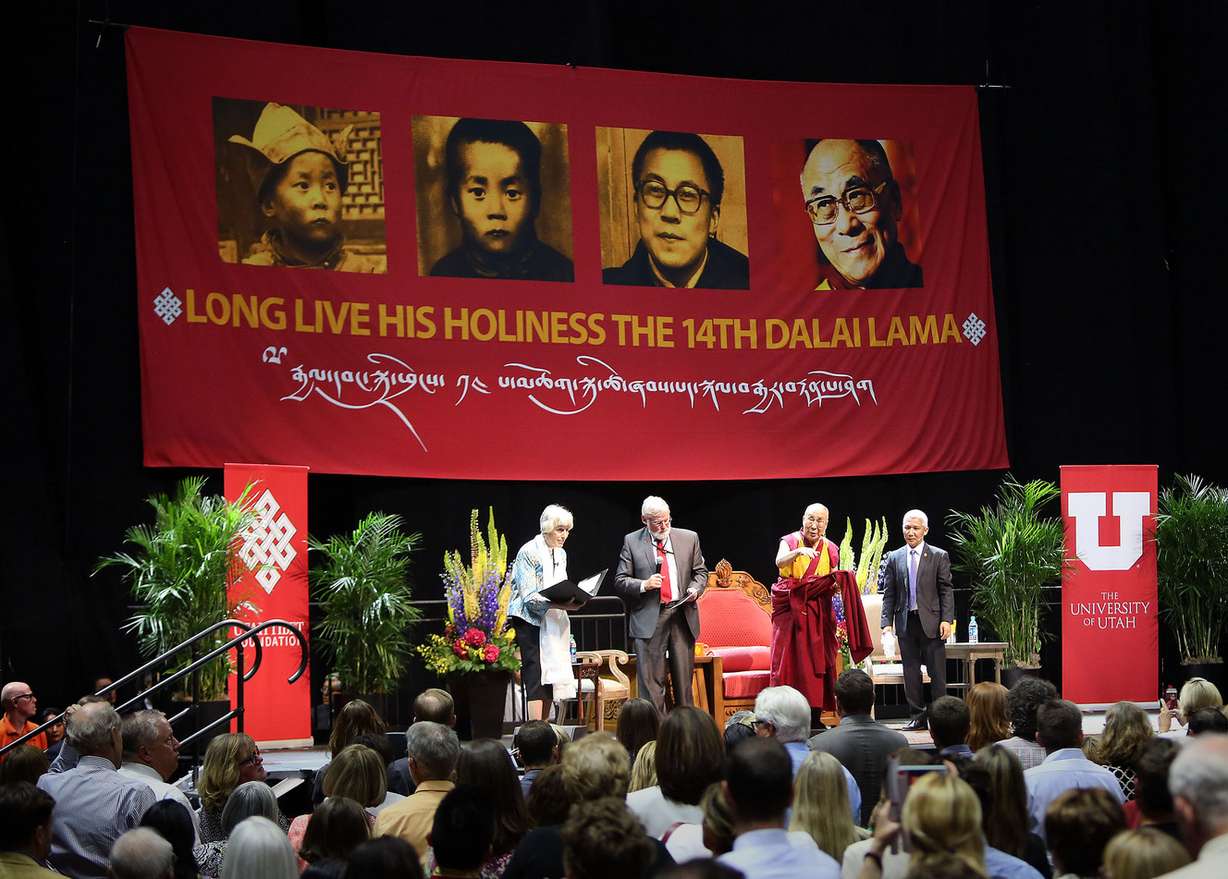 The Dalai Lama motions for people to sit back down as they give him a standing ovation after speaking at the Huntsman Center in Salt Lake City on Tuesday, June 21, 2016. (Photo: Kristin Murphy, Deseret News)