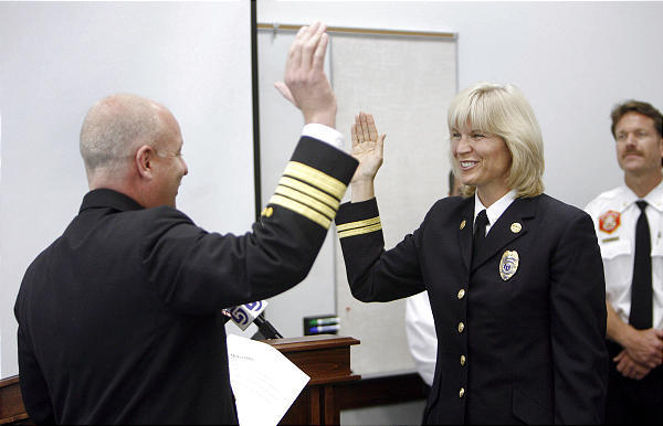 Martha Ellis is sworn in as the first woman division chief in the Salt Lake City Fire Department by Chief Tom Shannon on Thursday, May 7, 2009. (Photo: Stuart Johnson, Deseret News)