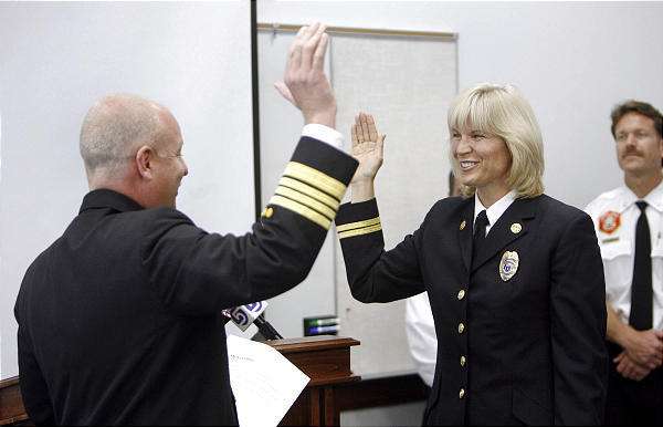 Martha Ellis is sworn in as the first woman division chief in the Salt Lake City Fire Department by Chief Tom Shannon on Thursday, May 7, 2009. (Photo: Stuart Johnson, Deseret News)
