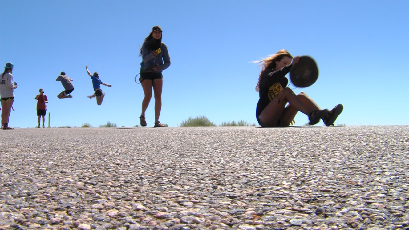 Tourists take photos at mile marker 13 on U.S. 163. The spot is featured in the 1994 film "Forrest Gump." It's the spot where Forrest Gump, played by Tom Hanks, decides to stop running. (Photo: Eric Betts, Deseret News)