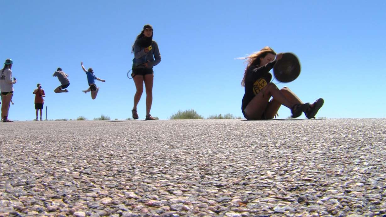 Tourists take photos at mile marker 13 on U.S. 163. The spot is featured in the 1994 film "Forrest Gump." It's the spot where Forrest Gump, played by Tom Hanks, decides to stop running. (Photo: Eric Betts, Deseret News)