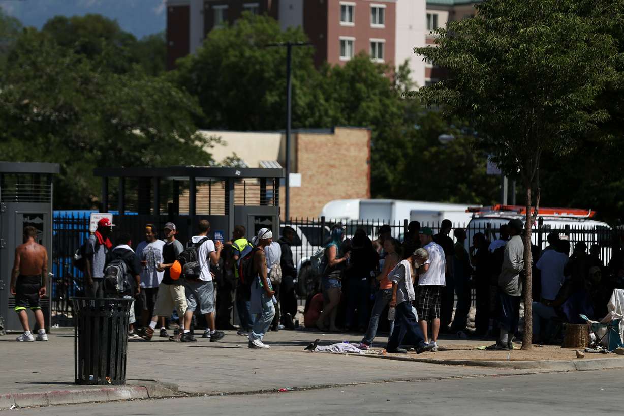 People stand by public toilets on 500 West near the Rio Grande Depot in Salt Lake City on Wednesday, June 22, 2016. (Photo: Spenser Heaps, Deseret News)