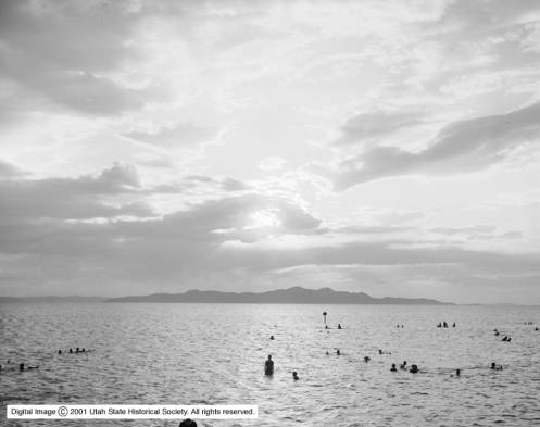 People are swimming in the water of the Great Salt Lake during a sunset in a photo dated Aug. 12, 1906. (Photo: Utah Historical Society)