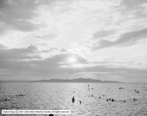 People are swimming in the water of the Great Salt Lake during a sunset in a photo dated Aug. 12, 1906. (Photo: Utah Historical Society)