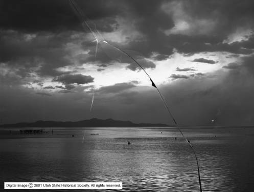 People swimming in the Great Salt Lake with Antelope Island in the background in a photo taken sometime around 1910. (Photo: Utah Historical Society)