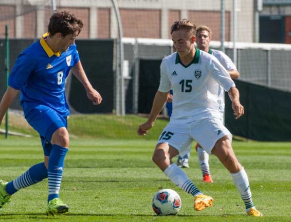 UVU midfielder Paul Hoffmeister attempts to dribble around UMKC midfielder Hamish Smylie. (Photo: James Durrant)