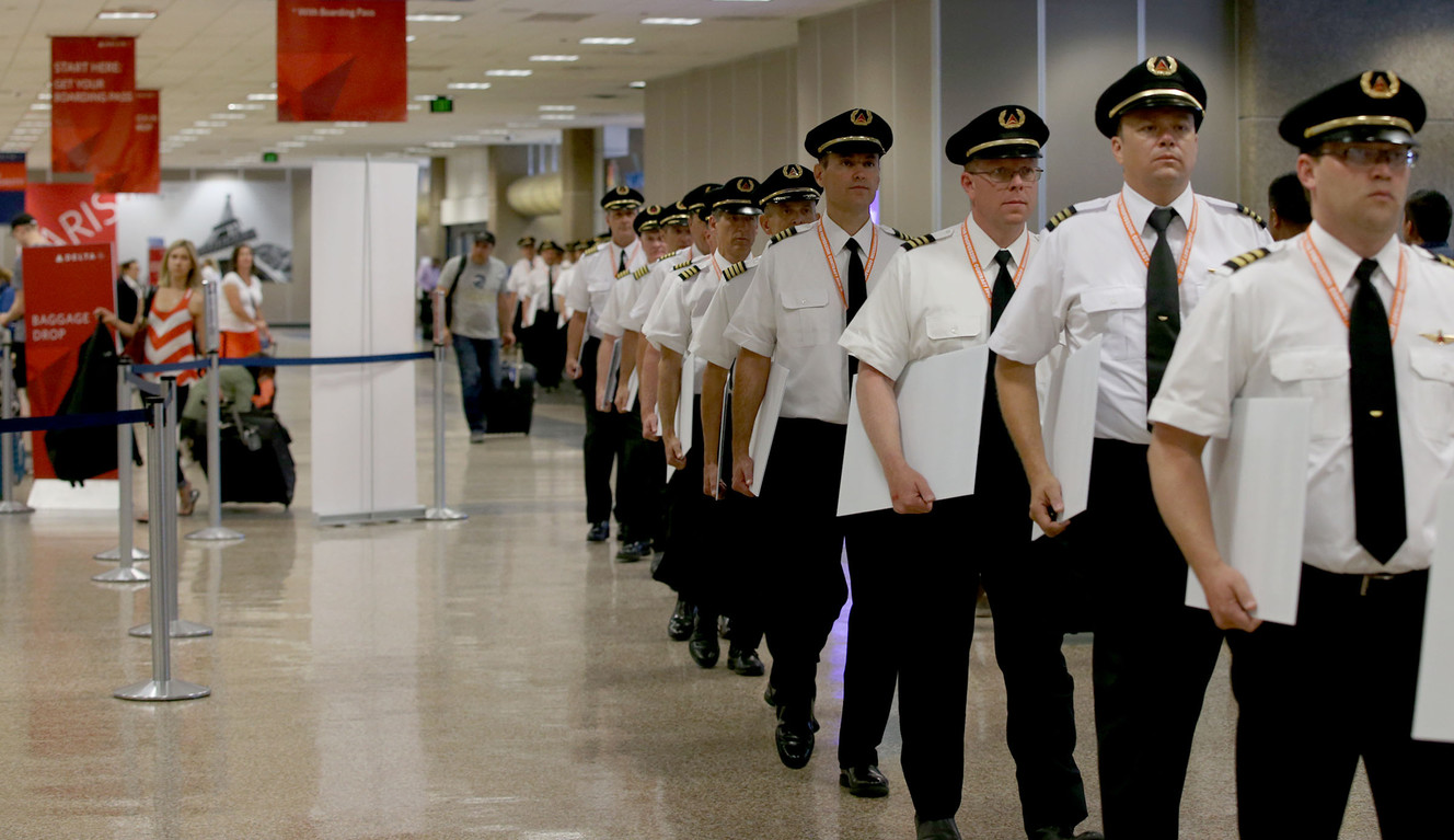 Delta Air Line pilots walk through the Delta Terminal at the Salt Lake City International Airport on Friday, June 24, 2016, while conducting informational picketing to raise the sense of urgency in the ongoing negotiations. Over five months have passed since the contract's amendable date. Fifteen months of negotiations have passed and the Delta pilots are still awaiting a new agreement. (Photo: Laura Seitz, Deseret News)