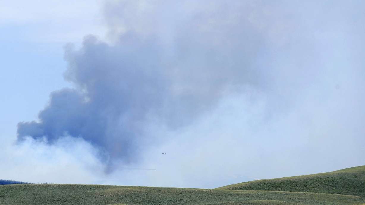 The Latest: Possible human remains found in wildfire
