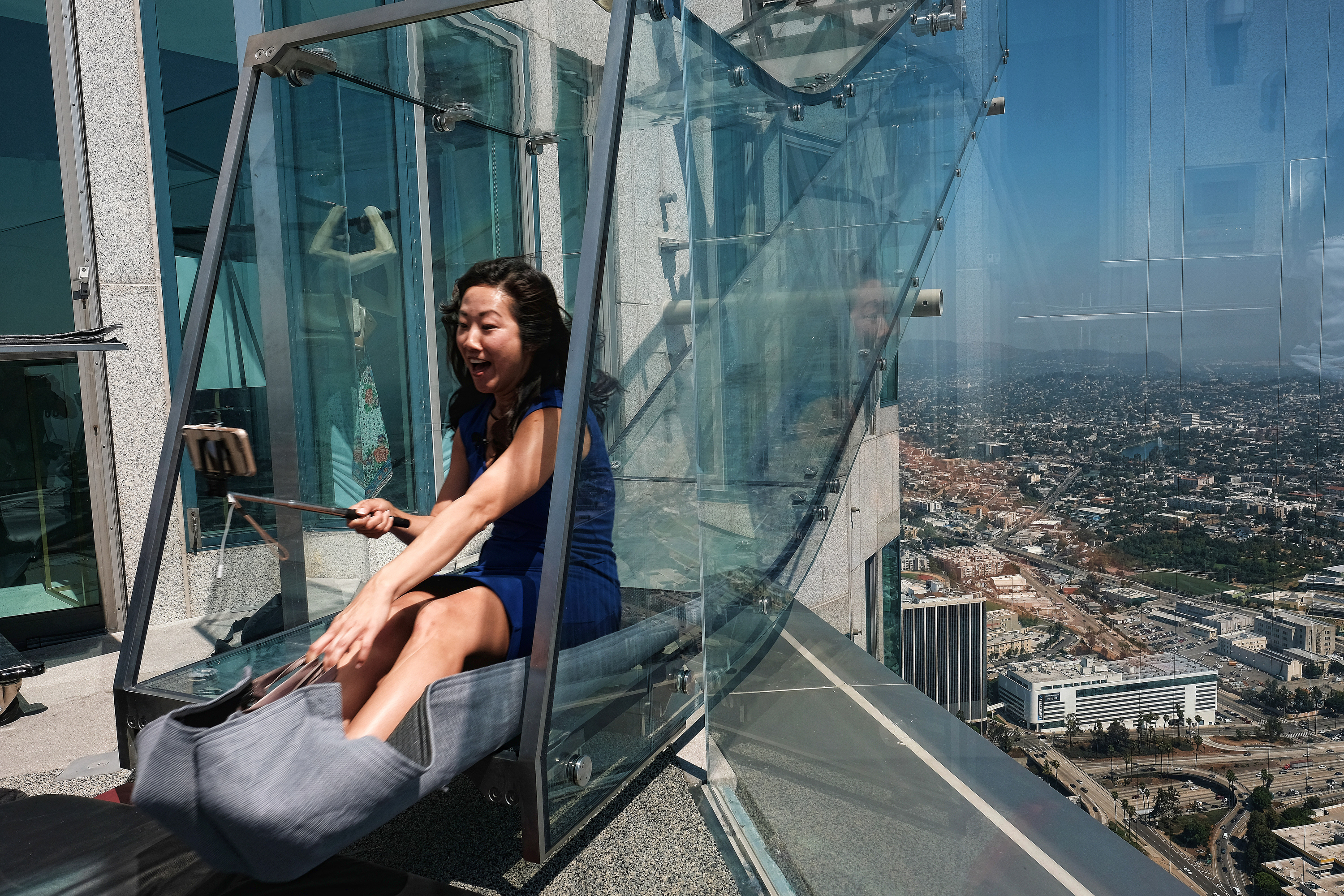 Starting this weekend, thrill-seekers can begin taking the “Skyslide” a 1,000 feet high and perched on the outside of the tallest skyscraper west of the Mississippi. (AP Photo/Richard Vogel)
