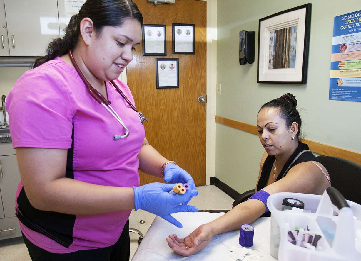 Medical Assistant Adalady Caloca, left, and Lorena Garcia talk after Garcia's blood draw in Midvale on Thursday, June 23, 2016. (Photo: Hans Koepsell, Deseret News)