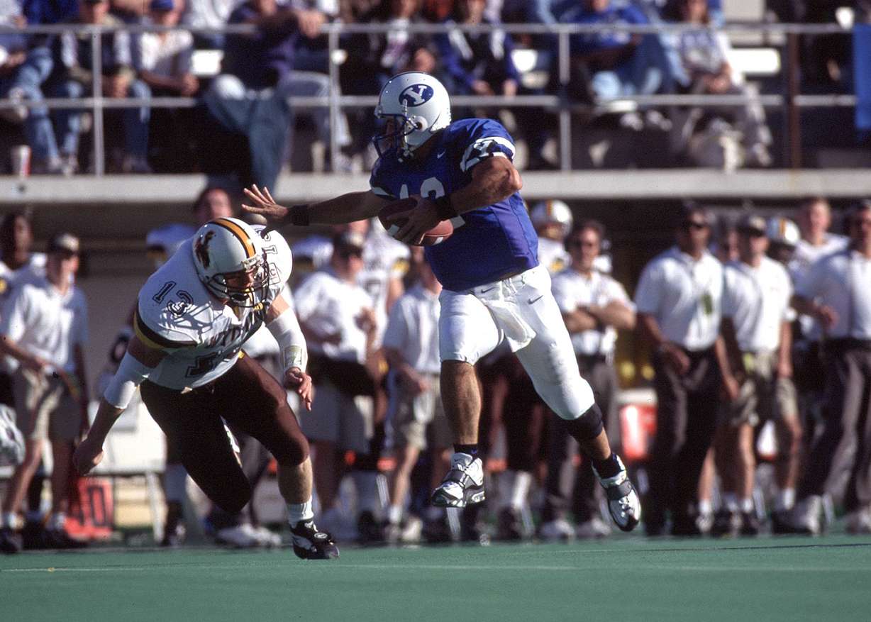 BYU quarterback Steve Sarkisian runs against Wyoming during a 28-25 win in 1996. (Photo: Mark A. Philbrick, BYU Photo)