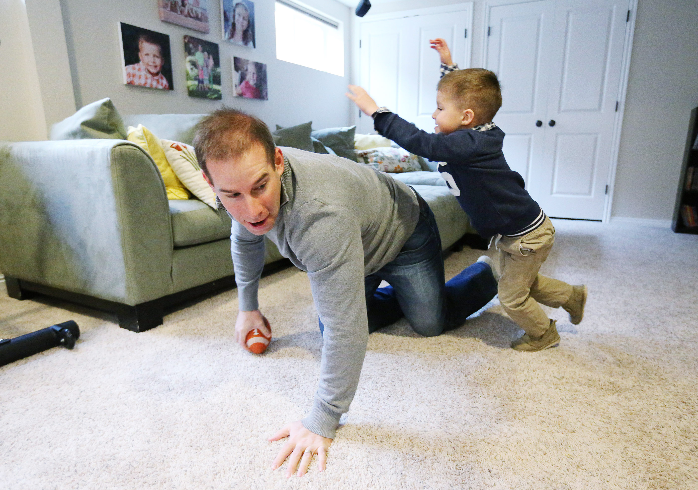 Morgan Scalley, Utes' new defensive coordinator and former player, plays football with his son Andrew at his home in Holladay (Photo: Jeffrey D. Allred, Deseret News)