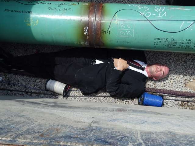 Environmental activist Tim DeChristopher lies in a trench where a natural gas pipeline is being built through the West Roxbury neighborhood of Boston on Wednesday, June 29, 2016. DeChristopher was among 26 of the protesters who entered the construction site and were arrested. DeChristopher served two years in federal prison for a previous act of civil disobedience, disrupting a Bureau of Land Management oil and gas lease auction in Utah. (Photo: Peter Bowden)