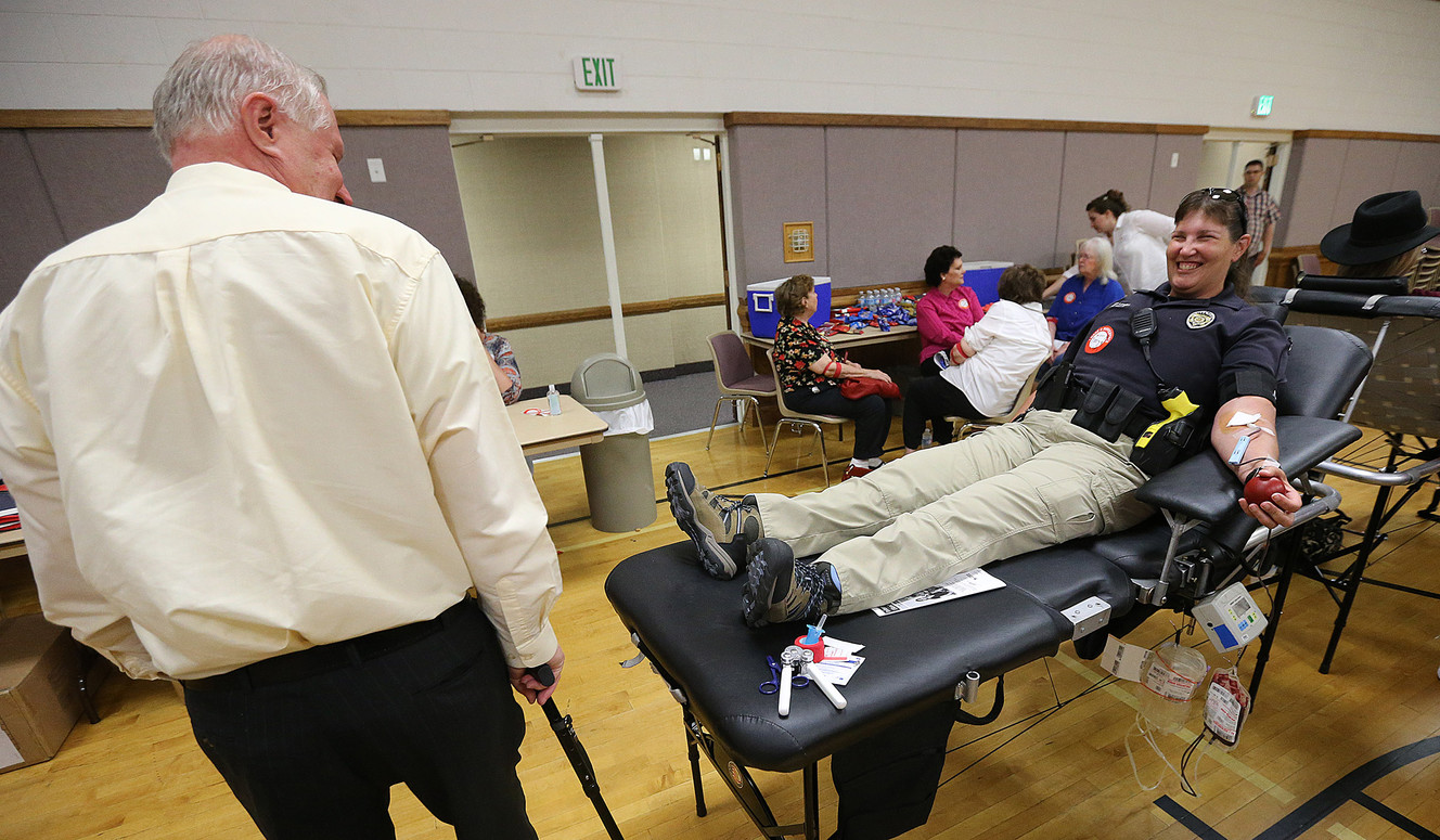 Unified police officer Tonya Lovell smiles at West Jordan police officer Cory Jensen as she donates blood at a drive in his honor in West Jordan on Friday, July 1, 2016. Jensen is recovering from Guillain-Barre syndrome. (Photo: Scott G Winterton, Deseret News)