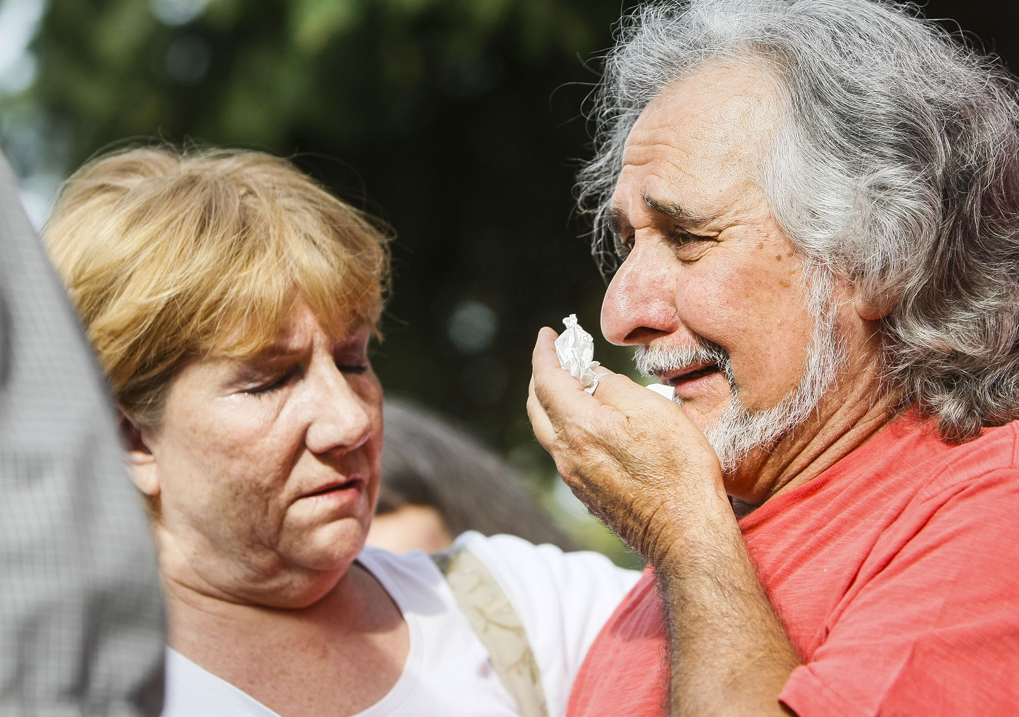 Lou Micallef, right, the grandfather of Maddison Haan, 20, is embraced by Leota Perkins during a vigil in Roy on Friday, July 1, 2016. The vigil was for Tyler Christianson, 19, and Maddison Haan, 20, who died while driving after being hit by Marilee Patricia Gardner, 16, who was going 100 mph and attempting to commit suicide. (Photo: Weston Kenney, Deseret News)