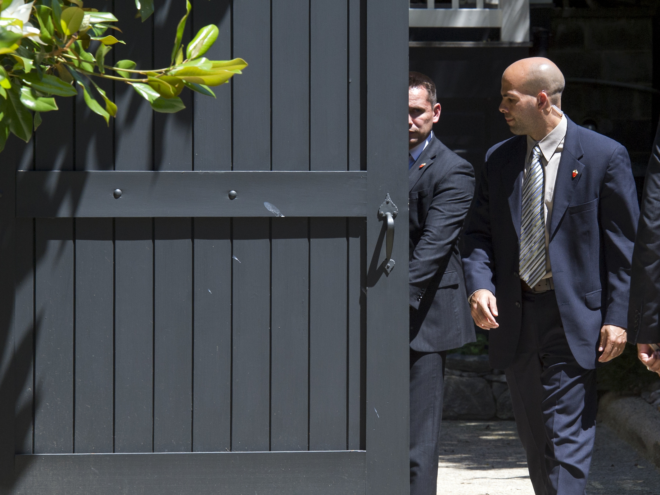 Secret Service agents close a gate at the home of Democratic presidential candidate Hillary Clinton after two Secret Service vehicles arrived, in Washington, Saturday, July 2, 2016. (AP Photo/Cliff Owen)
