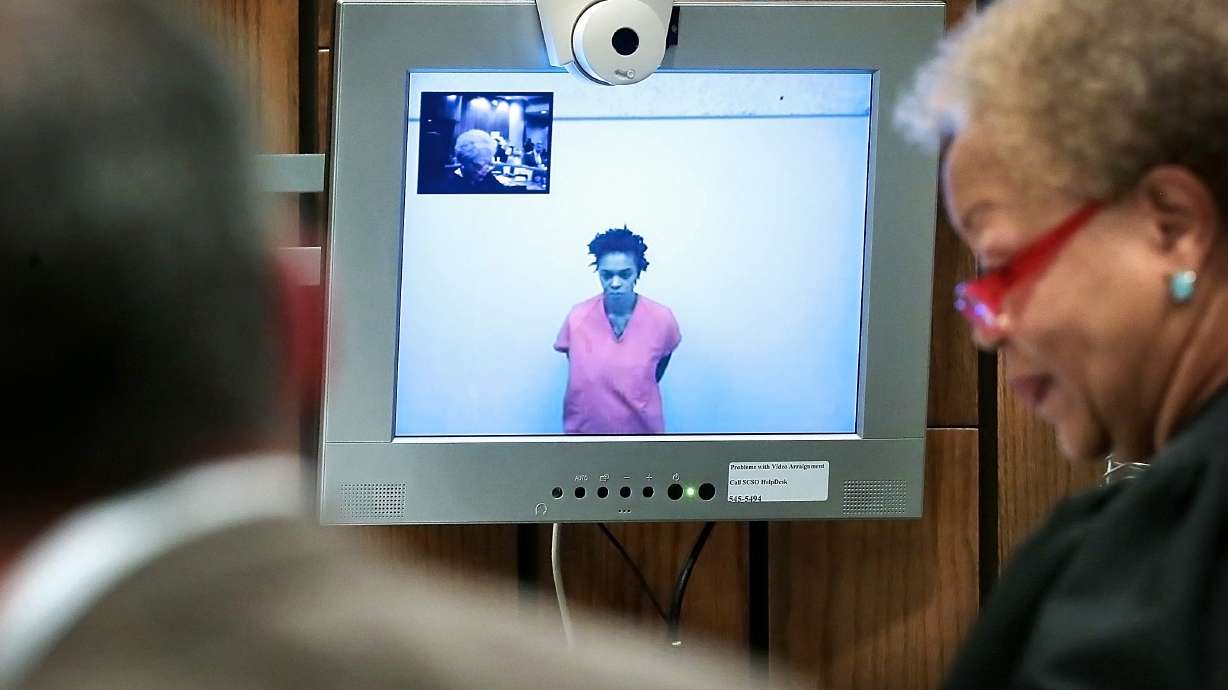 The Latest: Mom charged in kids' deaths taken to institute