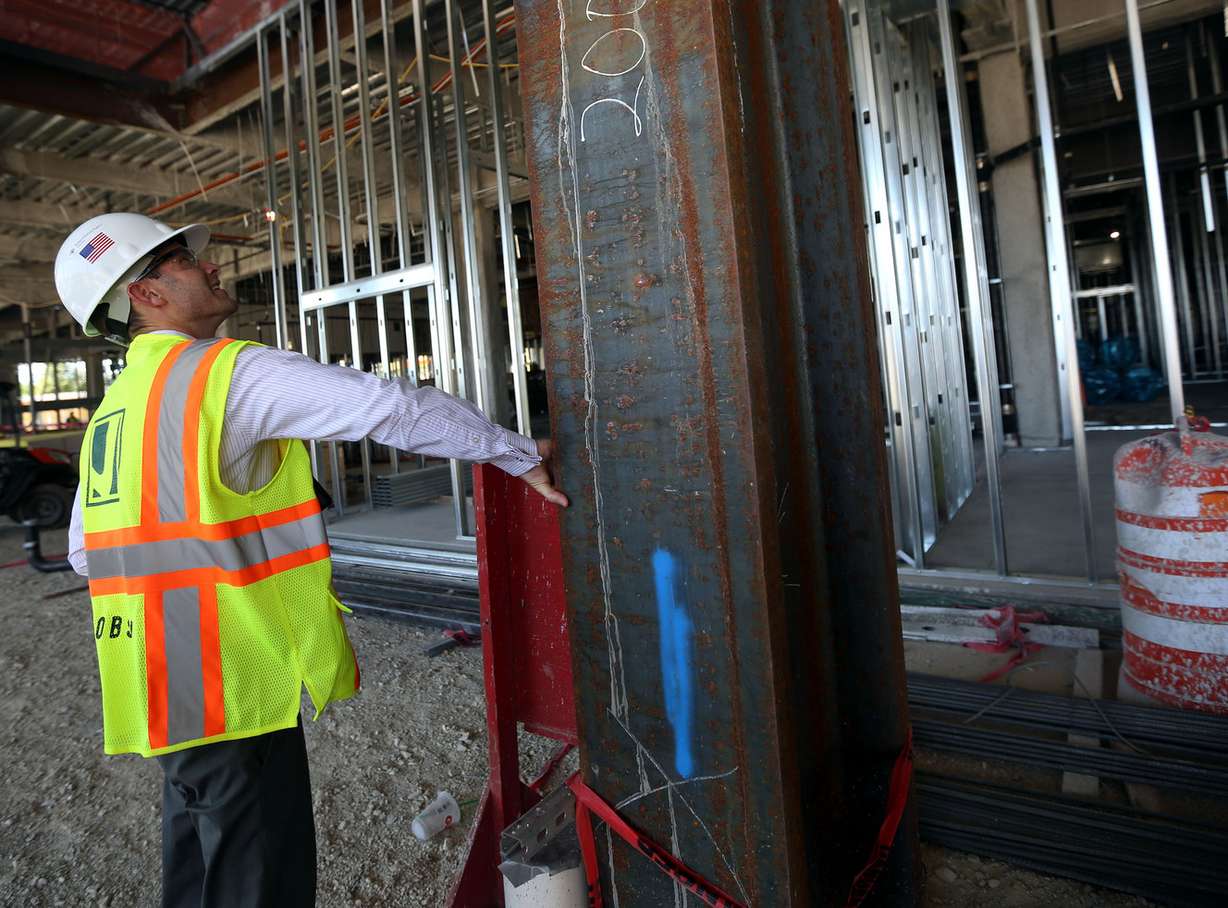 Josh Rohatinsky, project manager, feels the thickness of a steel support beam that weighs 26,000 lbs. in the new patient tower of Utah Valley Hospital in Provo on Tuesday, July 5, 2016. (Photo: Kristin Murphy, Deseret News)