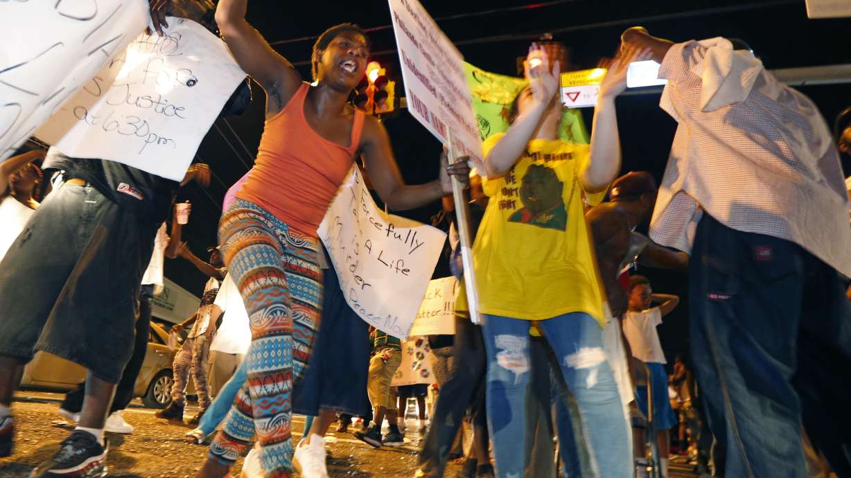 The Latest: Protesters gather outside police headquarters