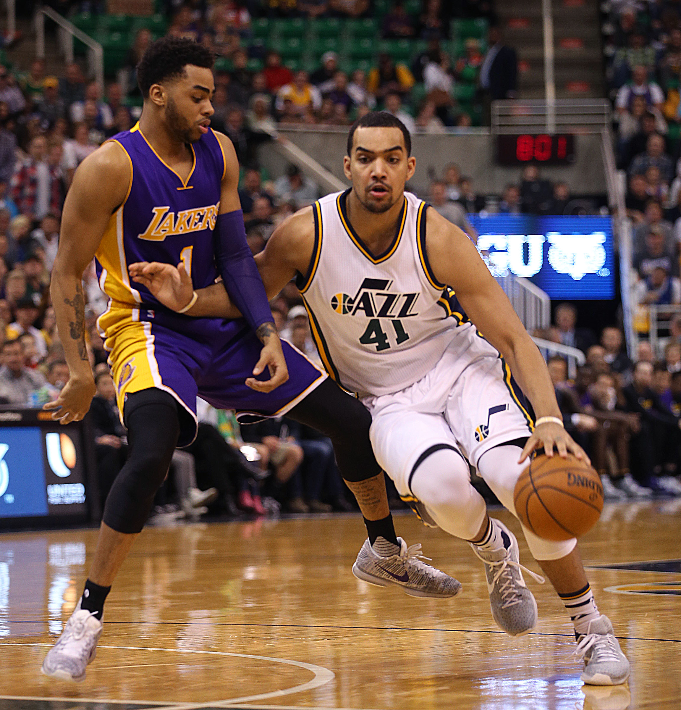 Utah Jazz's 41 Trey Lyles drives past Los Angeles' 1 D'Angelo Russell at the Vivint Smart Home Arena in Salt Lake City on Monday, March 28, 2016.