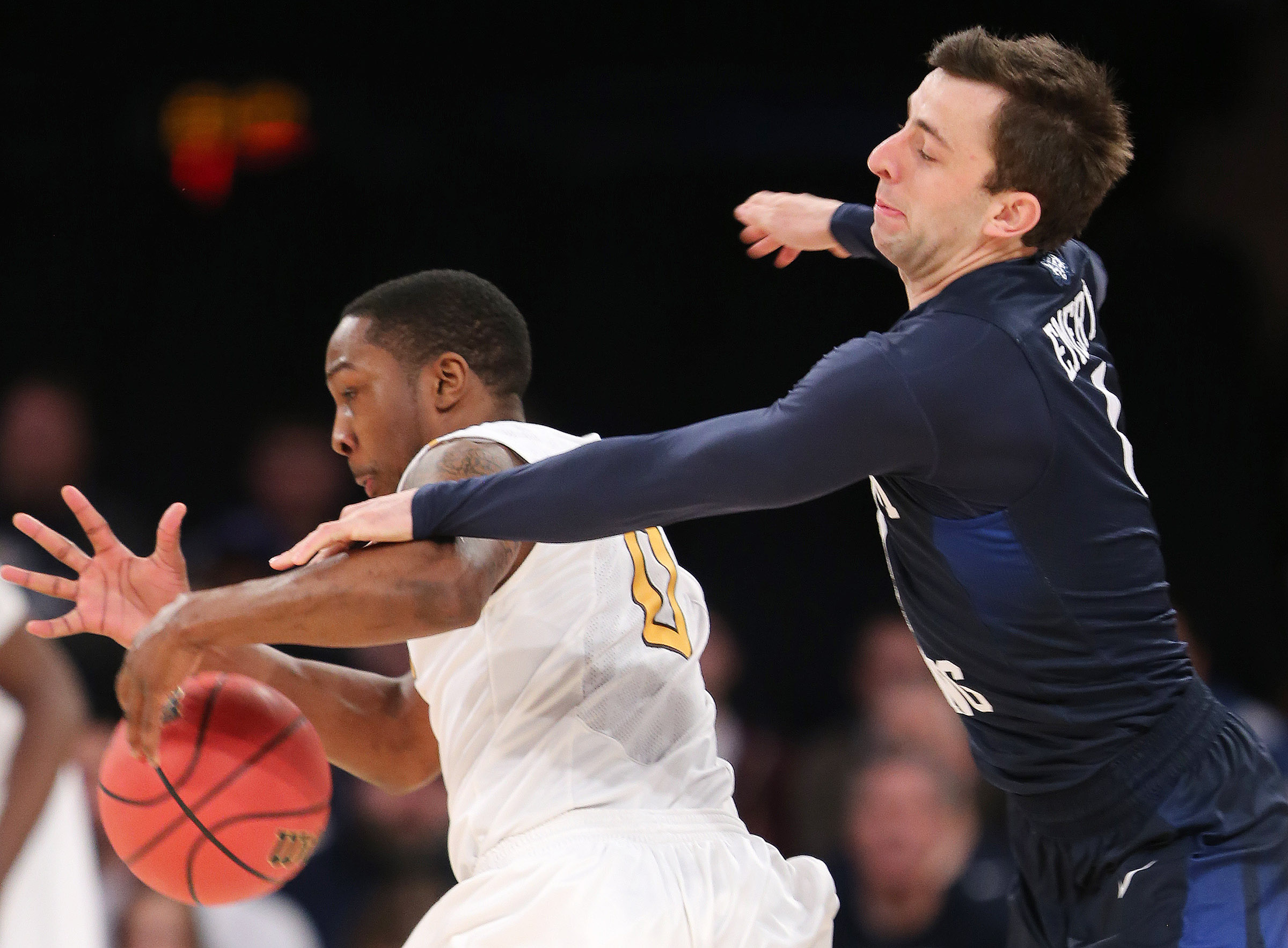 Brigham Young Cougars guard Nick Emery (4) knocks the ball away from Valparaiso Crusaders guard Keith Carter (0) as BYU and Valparaiso play in NIT Semifinal action at Madison Square Garden in New York City Tuesday, March 29, 2016. (Photo: Scott G. Winterton/Deseret News)