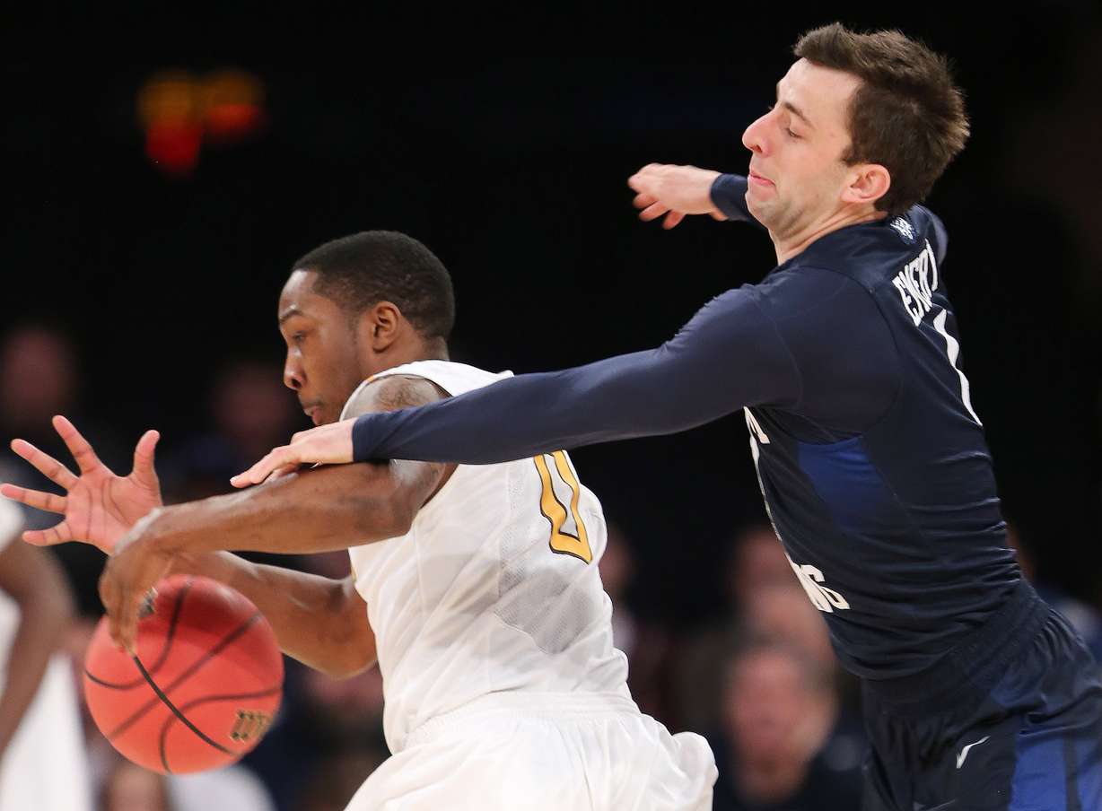 Brigham Young Cougars guard Nick Emery (4) knocks the ball away from Valparaiso Crusaders guard Keith Carter (0) as BYU and Valparaiso play in NIT Semifinal action at Madison Square Garden in New York City Tuesday, March 29, 2016. (Photo: Scott G. Winterton/Deseret News)