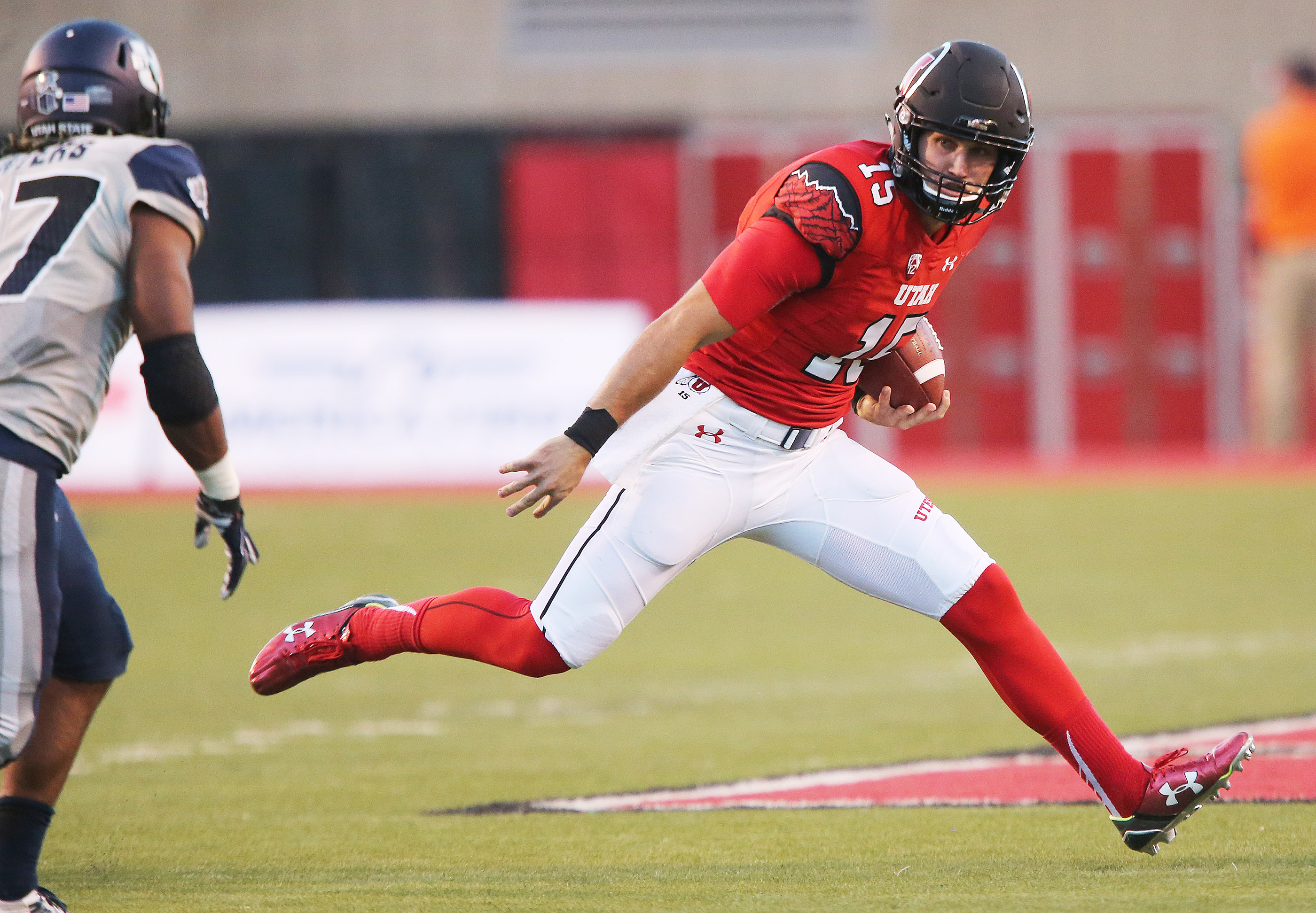 Utah Utes quarterback Chase Hansen (15) runs for extra yards against Utah State Aggies in Salt Lake City Friday, Sept. 11, 2015. Utah won 24-14. (Photo: Jeffrey D. Allred/Deseret News)