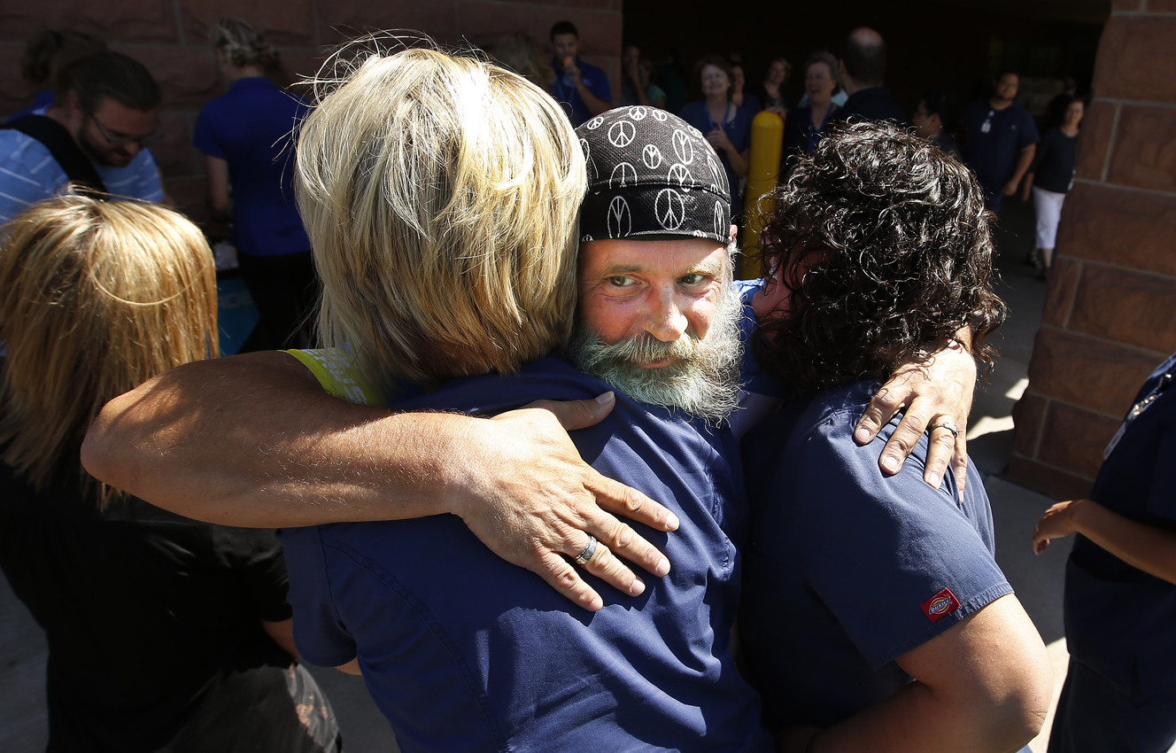 McKay-Dee Hospital employees get a hug from local cyclist and heart patient Bob Quick as he stopped in Ogden on Friday, July 8, 2016. A Roy paramedic saved Quick's life after a cardiac arrest in 2004 and he was brought to McKay-Dee Hospital for care. (Photo: Jeffrey D. Allred, Deseret News)