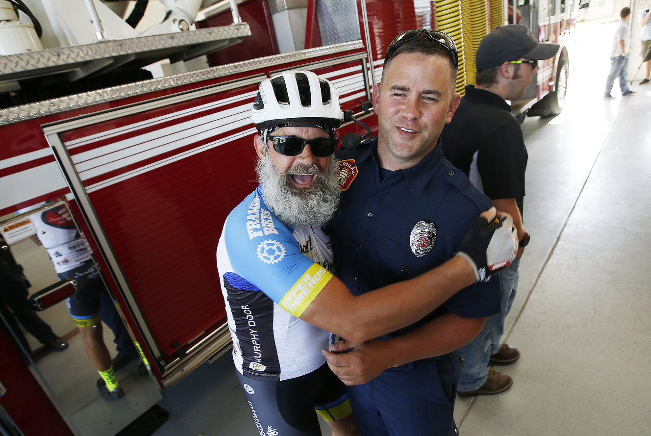 Local cyclist and heart patient Bob Quick clowns around with Roy firefighter Logan Layne in Roy on Friday, July 8, 2016. Layne saved his Quick's life after a cardiac arrest and he was brought to McKay-Dee Hospital for care. (Photo: Jeffrey D. Allred, Deseret News)