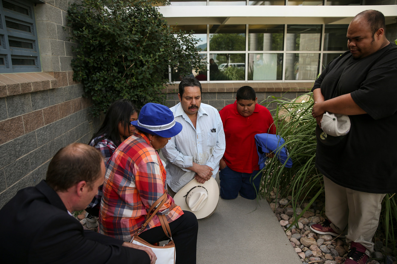 Martin Chairez-Castrejon, center, is joined in prayer by his attorney, Skyler Anderson, left, his daughter, Janet Chairez, his wife, Lorena Gonzalez, his nephew, Samuel Chairez, and his son, Martin Chairez Jr., after Chairez-Castrejon was released from the Utah County Jail, July 8, 2016. Photo: Spenser Heaps, Deseret News