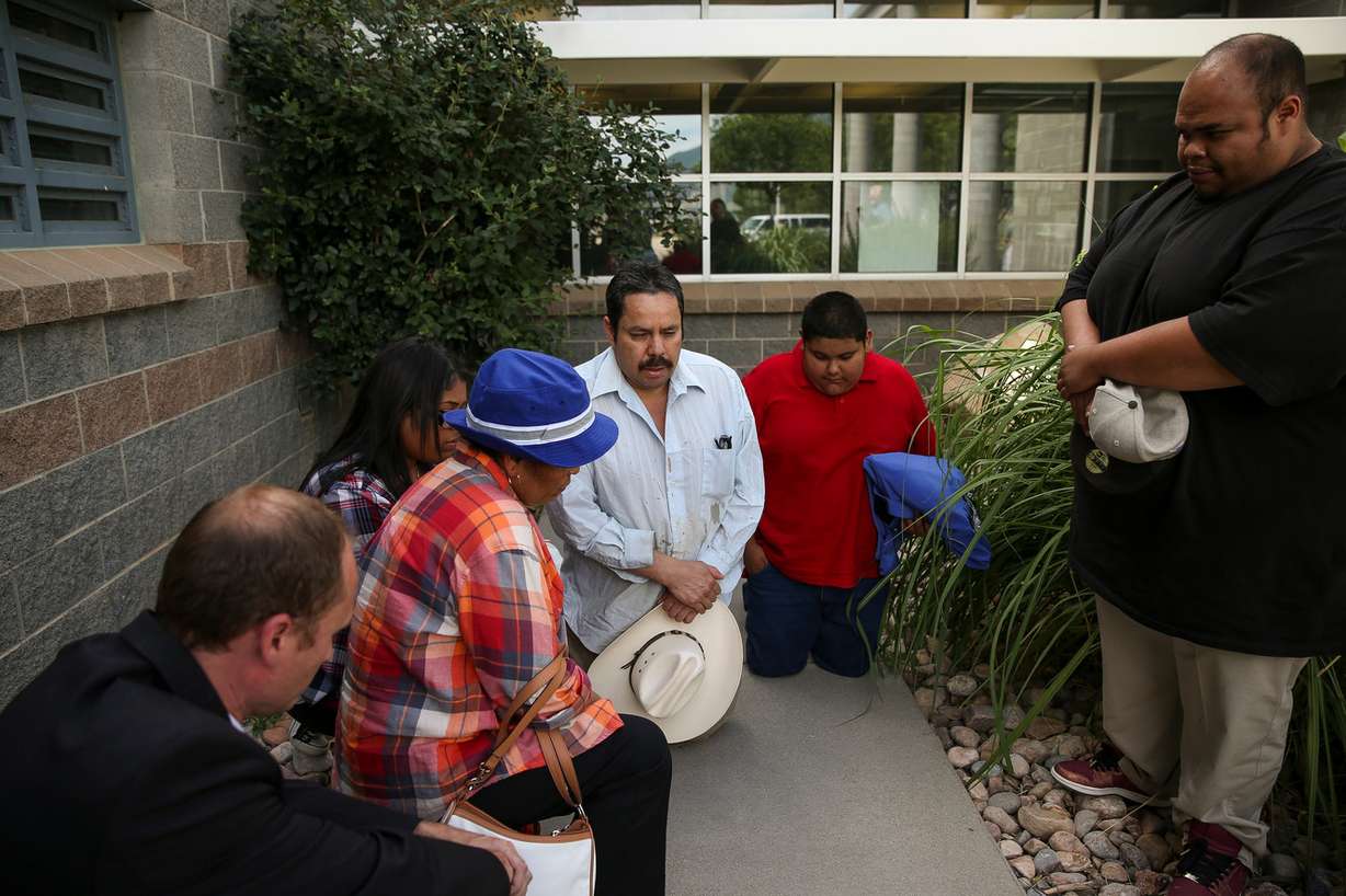 Martin Chairez-Castrejon, center, is joined in prayer by his attorney, Skyler Anderson, left, his daughter, Janet Chairez, his wife, Lorena Gonzalez, his nephew, Samuel Chairez, and his son, Martin Chairez Jr., after Chairez-Castrejon was released from the Utah County Jail, July 8, 2016. Photo: Spenser Heaps, Deseret News
