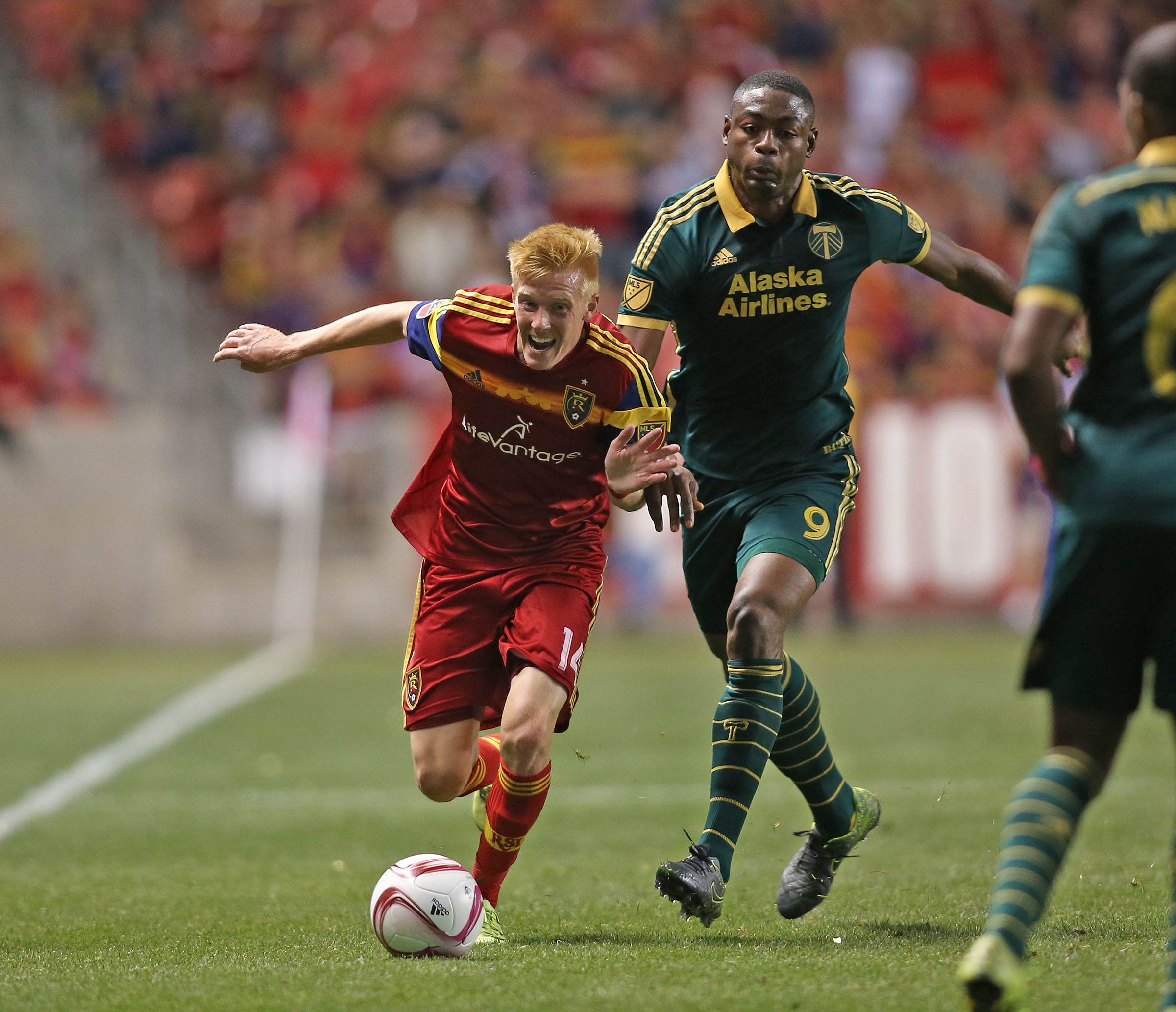 Real's Justen Glad goes by Portland Timbers forward Fanendo Adi (9) as the Real Salt Lake is defeated by the Portland Timbers 1-0 in play soccer Wednesday, Oct. 14, 2015, in Sandy. (Photo: Tom Smart, Deseret News)