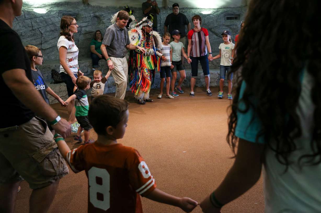 Visitors and performers dance in a circle inside the teepee at the Native American Village at This Is The Place Heritage Park in Salt Lake City on Wednesday, July 6, 2016. The park's new Native American Village is now open to the public. (Photo: Spenser Heaps, Deseret News)