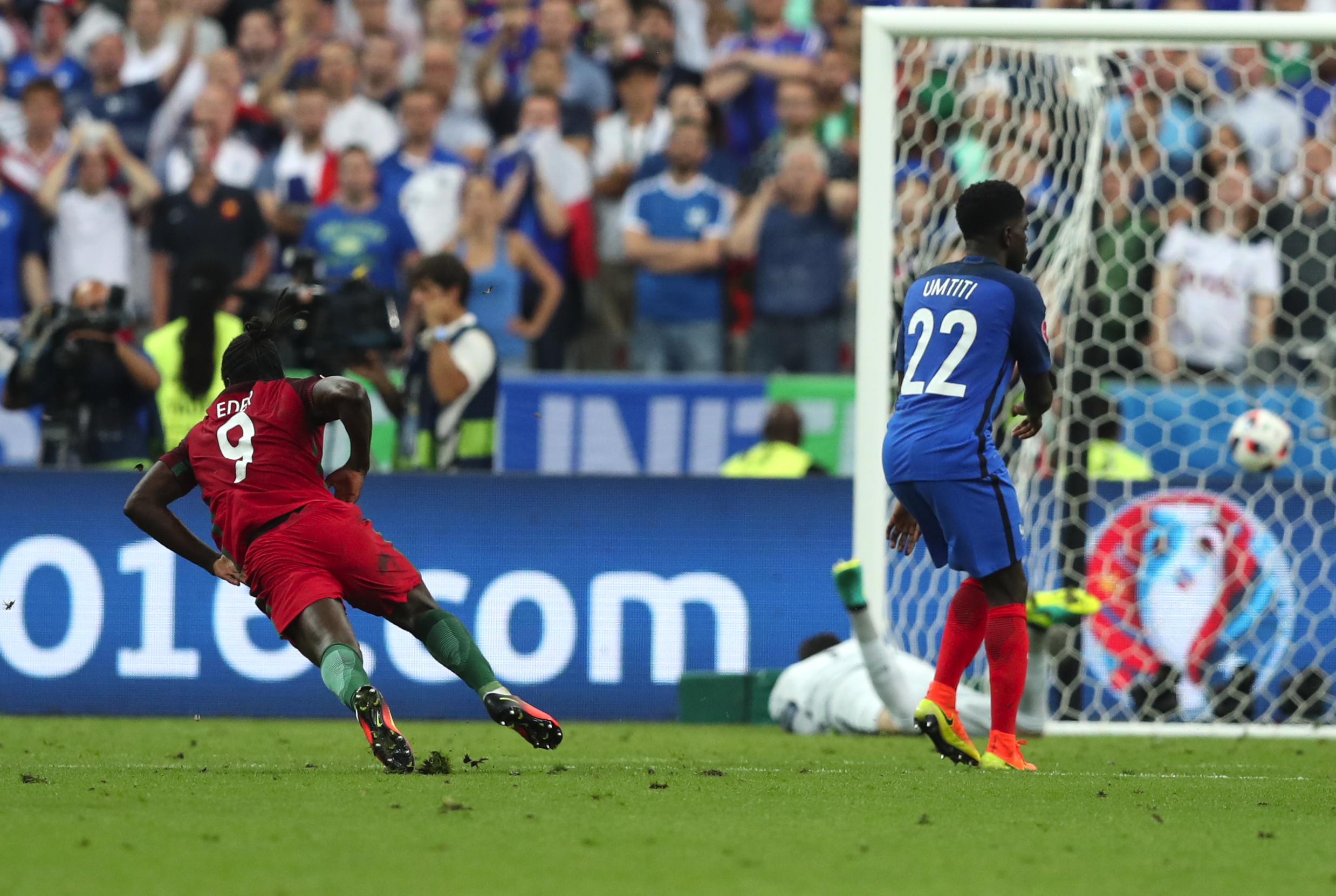 Portugal's Eder, left, scores the opening goal during the Euro 2016 final soccer match between Portugal and France at the Stade de France in Saint-Denis, north of Paris, Sunday, July 10, 2016. (AP Photo/Thanassis Stavrakis)