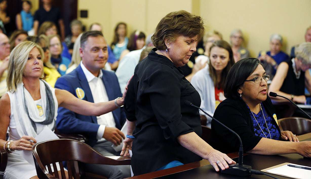 Patient Carrie Snyder, left, touches patient Janet LeMaire after LeMaire speaks in favor of end-of-life legislation at the Capitol in Salt Lake City on Wednesday, July 13, 2016. At right is Rep. Rebecca Chavez-Houck, D-Salt Lake City. (Photo: Ravell Call, Deseret News)