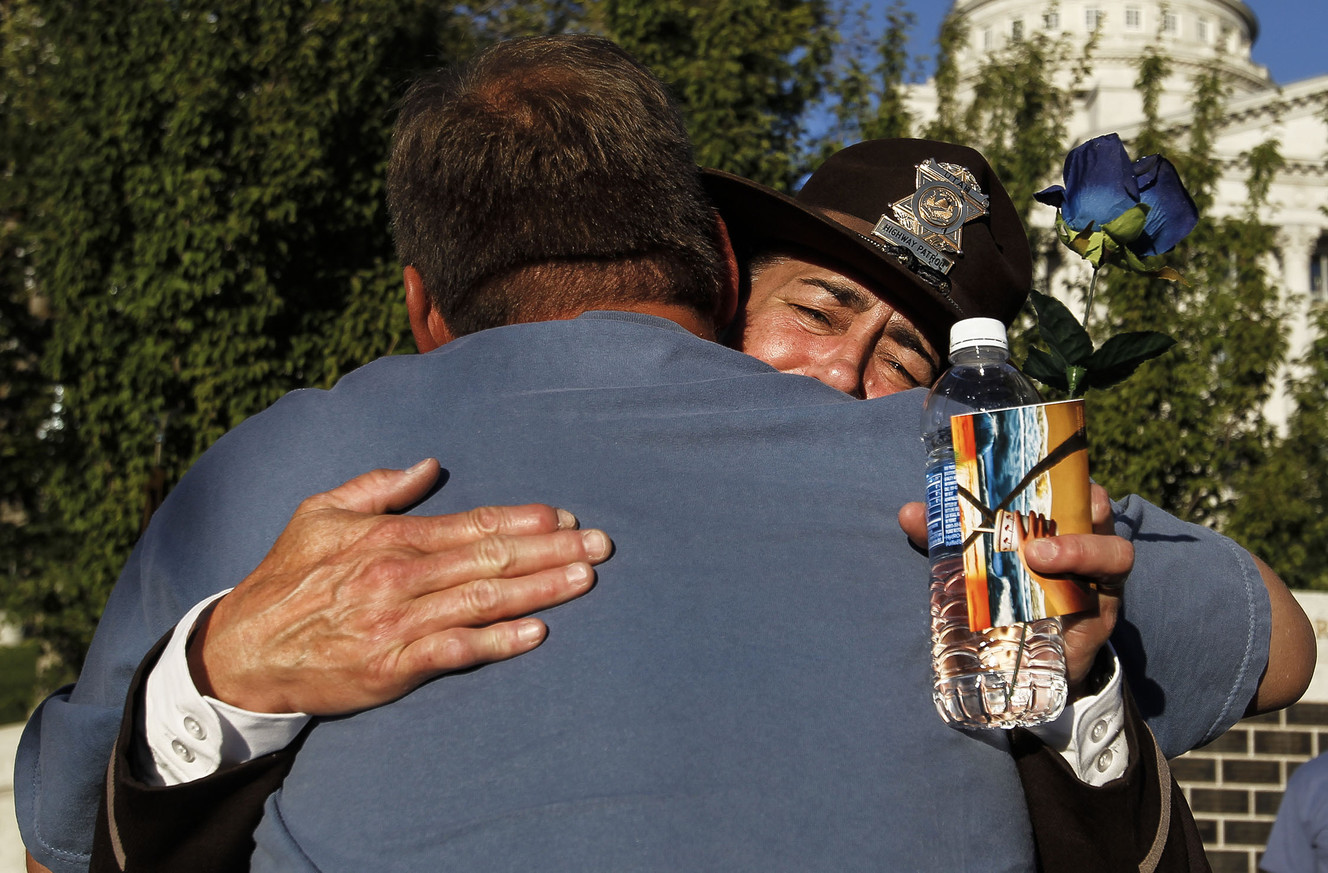 Michelle Hancock of the Utah Highway Patrol hugs David Shuman at the Utah Law Enforcement Memorial in Salt Lake City on Thursday, July 14, 2016, during a vigil to honor the Dallas police officers killed and injured in the line of duty last week. (Photo: Weston Kenney, Deseret News)