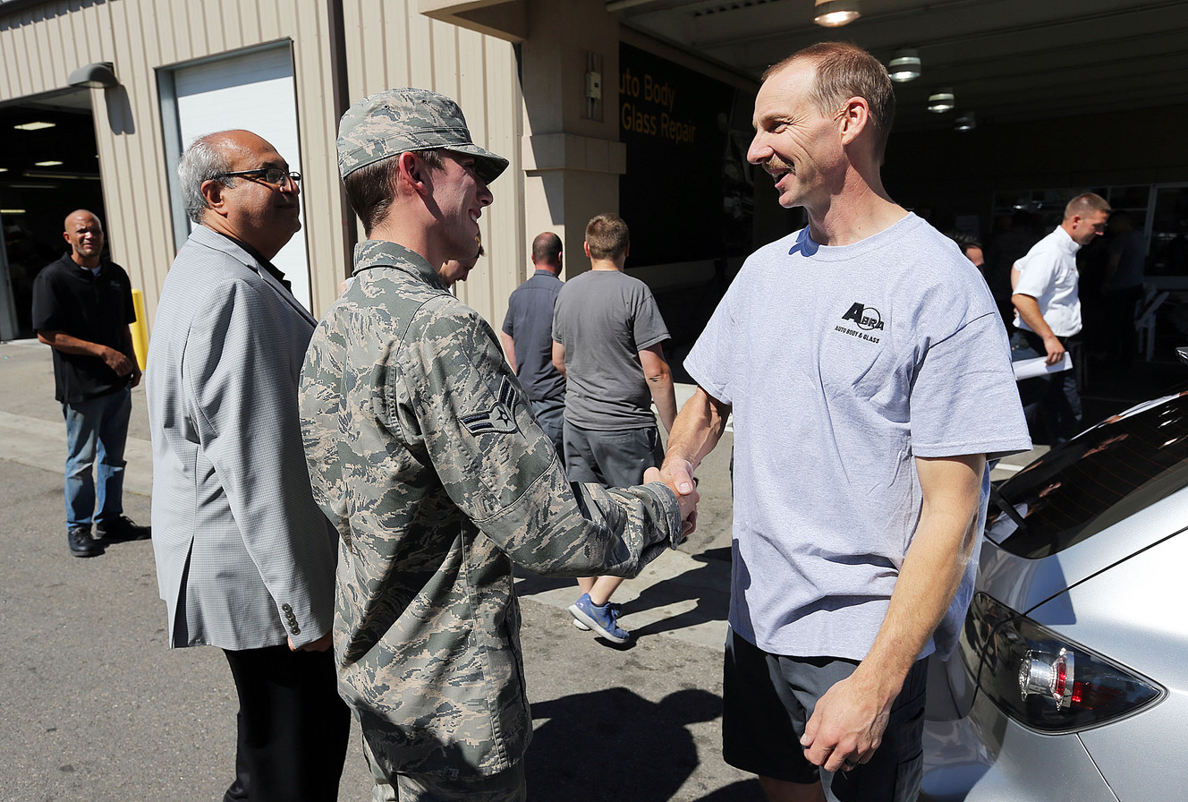 Airman 1st Class Jacob Lang, left, is greeted by Jordon Andersen, who repaired his car, at ABRA Auto Body & Glass in Clearfield on Thursday, July 14, 2016. (Photo: Ravell Call, Deseret News)