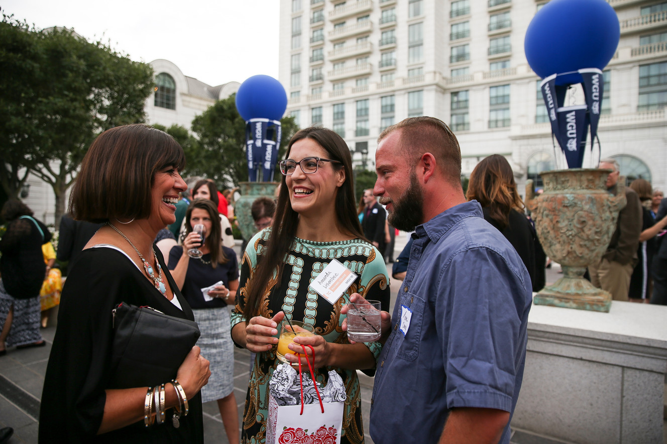 Amanda Suni Lisonbee, center, and her boyfriend Tom Conrad, right, talk to Lisonbee's mentor Lori Ellwanger, left, at a graduation party for Western Governors University at the Grand America Hotel in Salt Lake City on Friday, July 15, 2016. (Photo: Spenser Heaps, Deseret News)