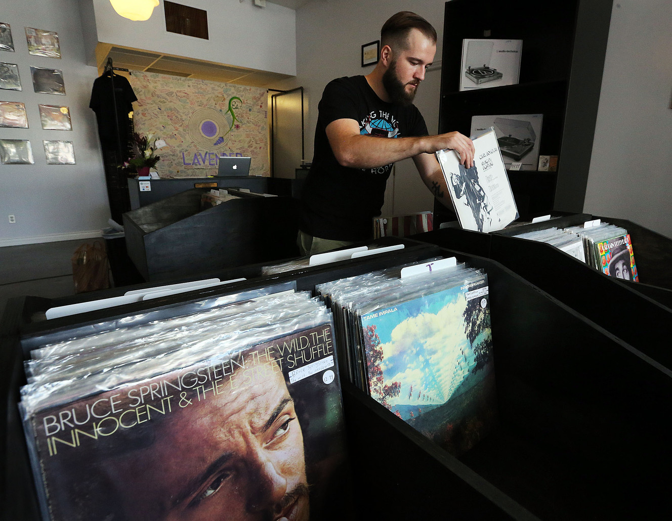 Co-owner Blake Lundell organizes record albums at Lavender Vinyl in Ogden on Tuesday, July 5, 2016. (Photo: Ravell Call, Deseret News)