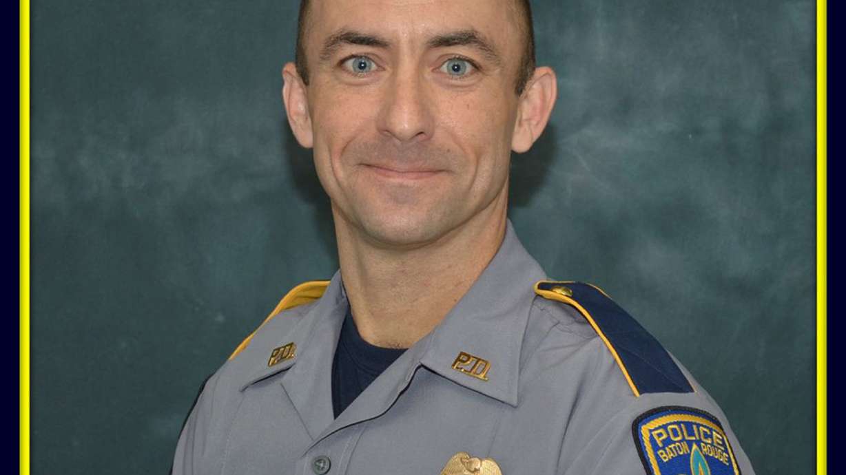 The Latest: Candlelight vigil honors slain police officer