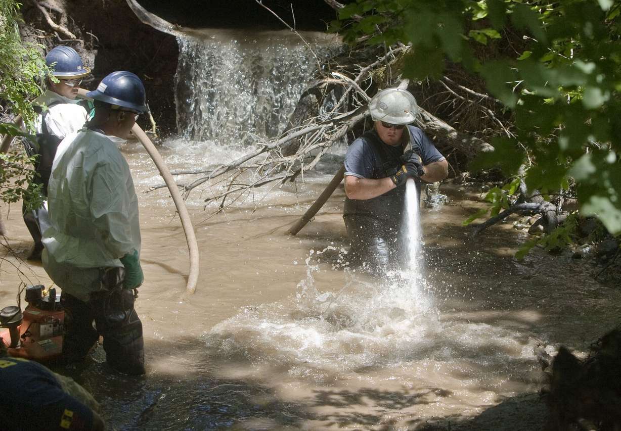 Members of the Red Butte Canyon Spill Unified Command Cleanup Operation crew uses a fire float to wash the bank of Red Butte Creek behind the Veterans Medical Center in Salt Lake City on June 28, 2010. Six years after a ruptured pipeline sent 800 barrels of oil into the creek, Chevron says it is as clean as other urban waterways and water quality monitoring should cease. (Photo: Deseret News Archives)